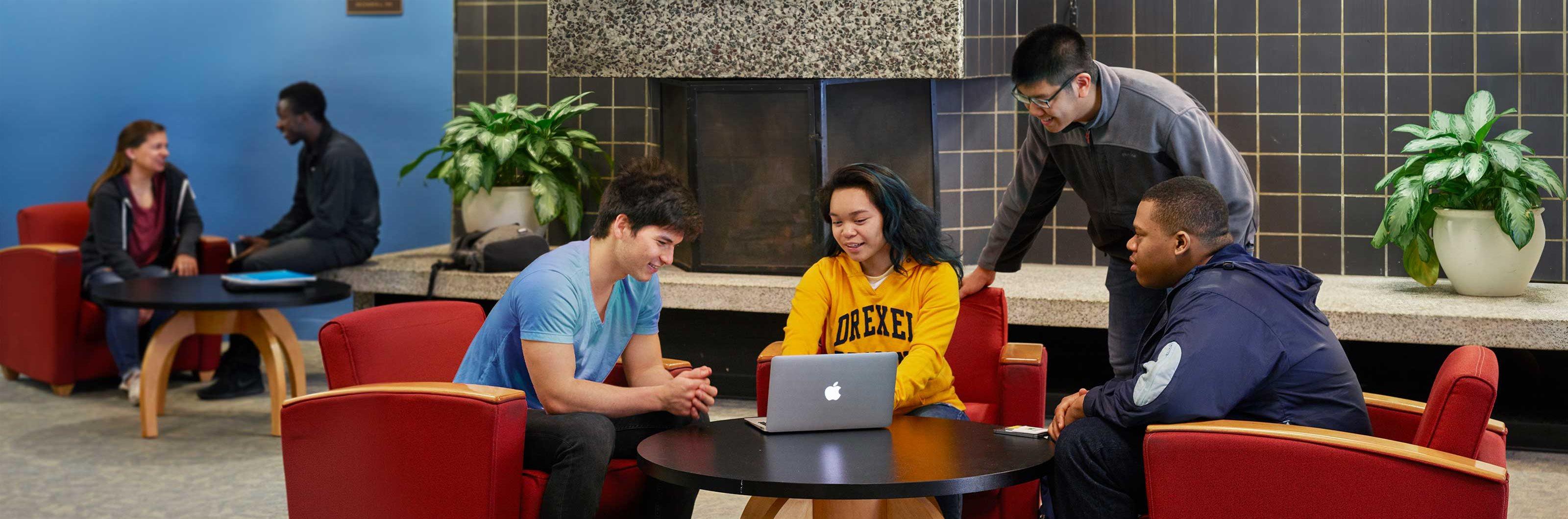 Drexel students socialize around a computer
