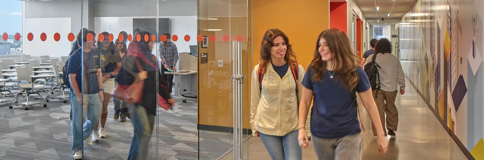 Drexel students exiting a classroom and walking down the hall