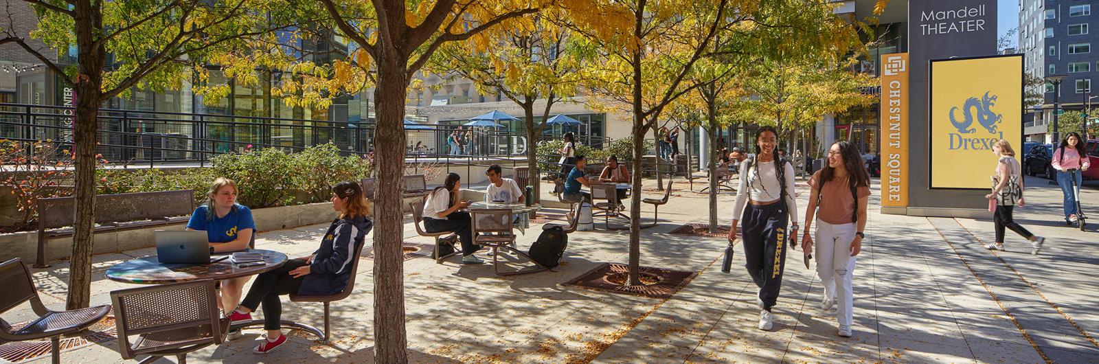 Drexel students walking in Chestnut square during the fall