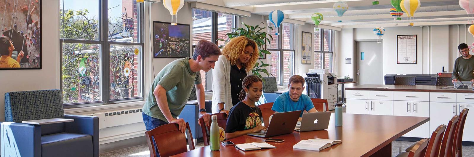 Drexel students gathered around a computer