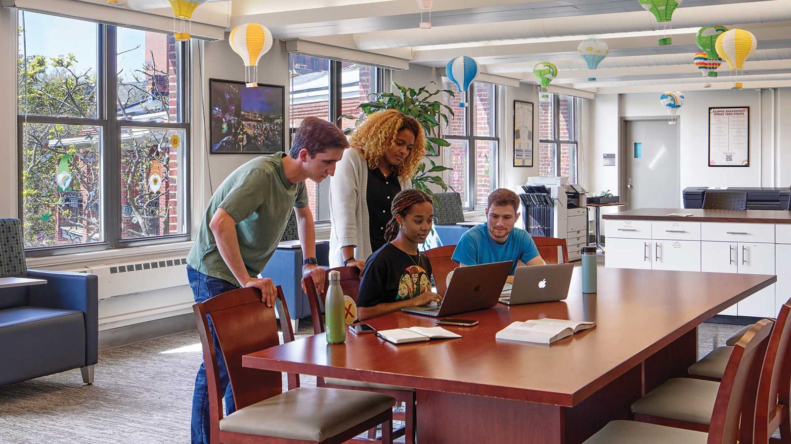 Drexel students gathered around a computer