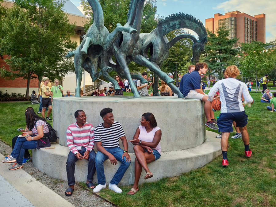 Students sitting in front of sculpture on Drexel campus