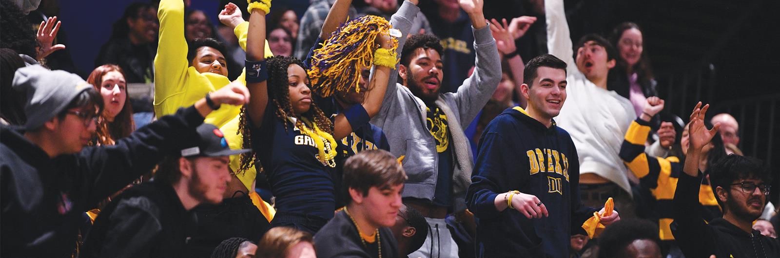 Drexel fans cheering at a Basketball game. 