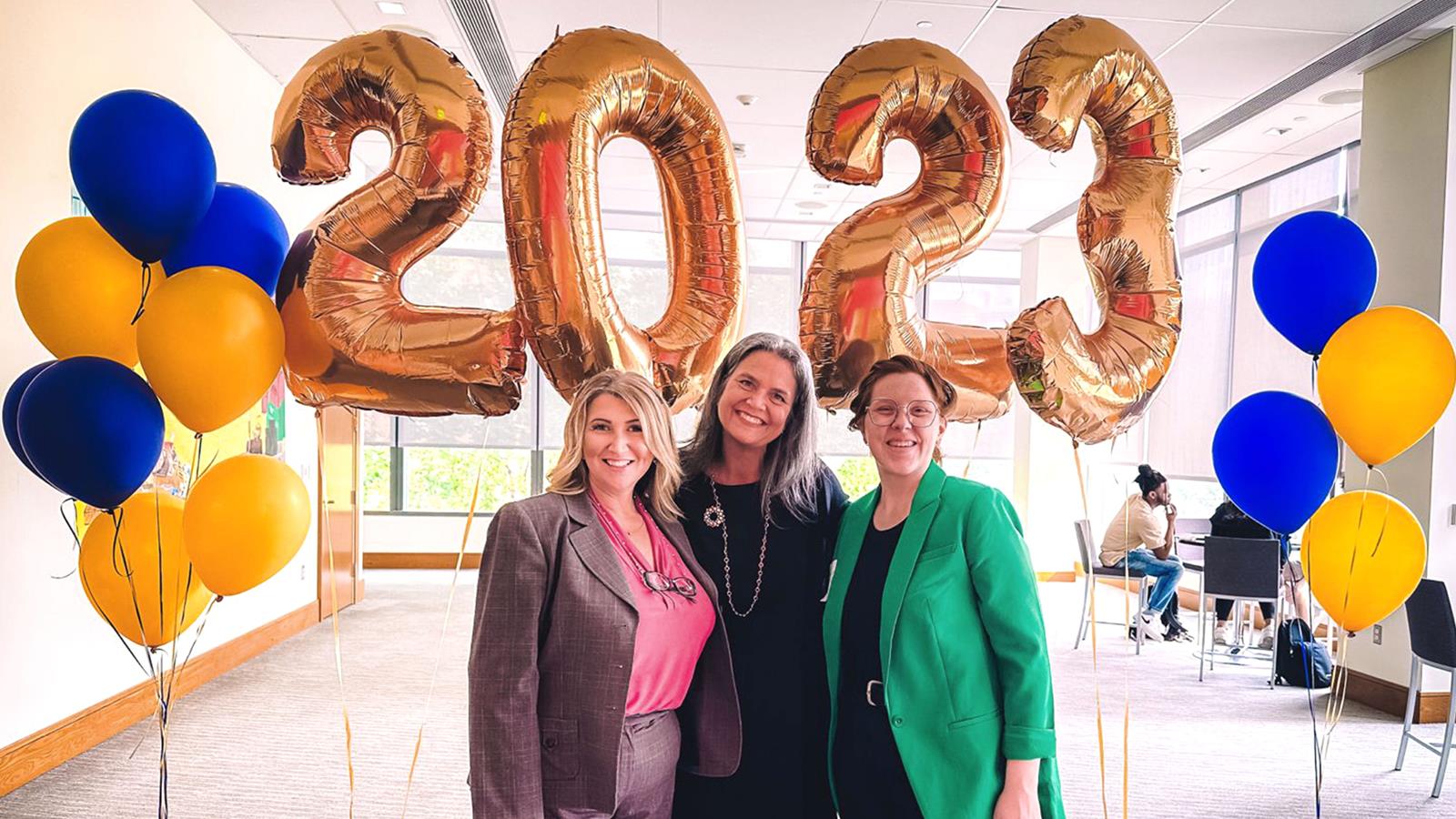 3 women in front of 2023 year Balloons