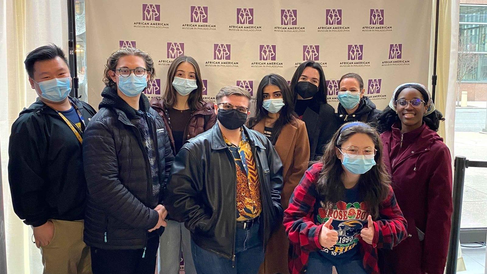 Students in front of an AAMP banner