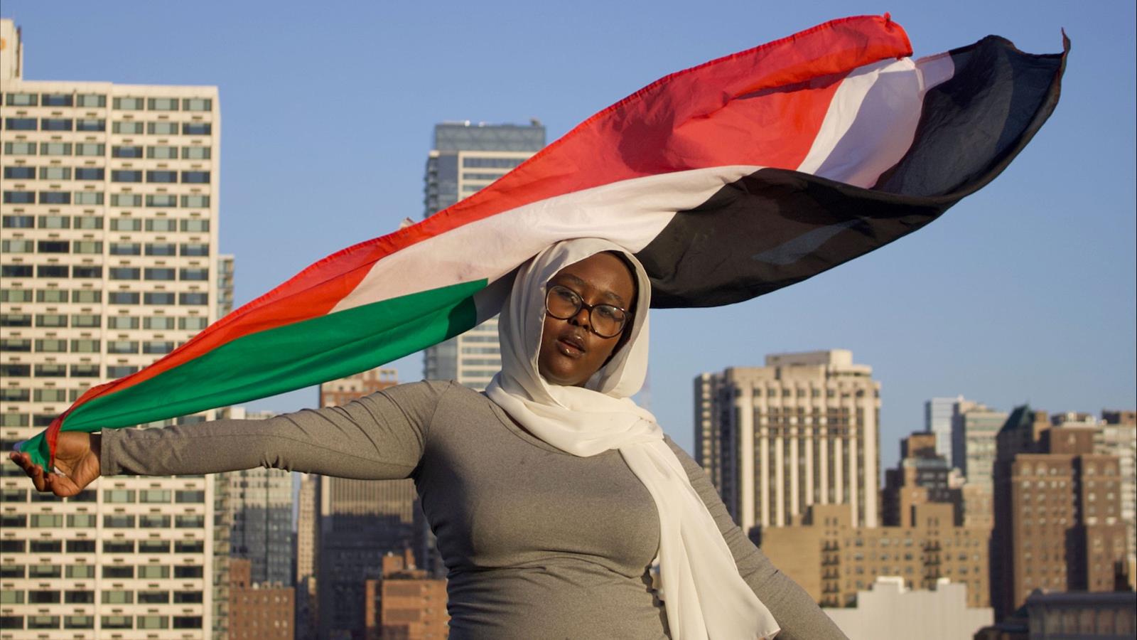 Student waving a flag on a roof