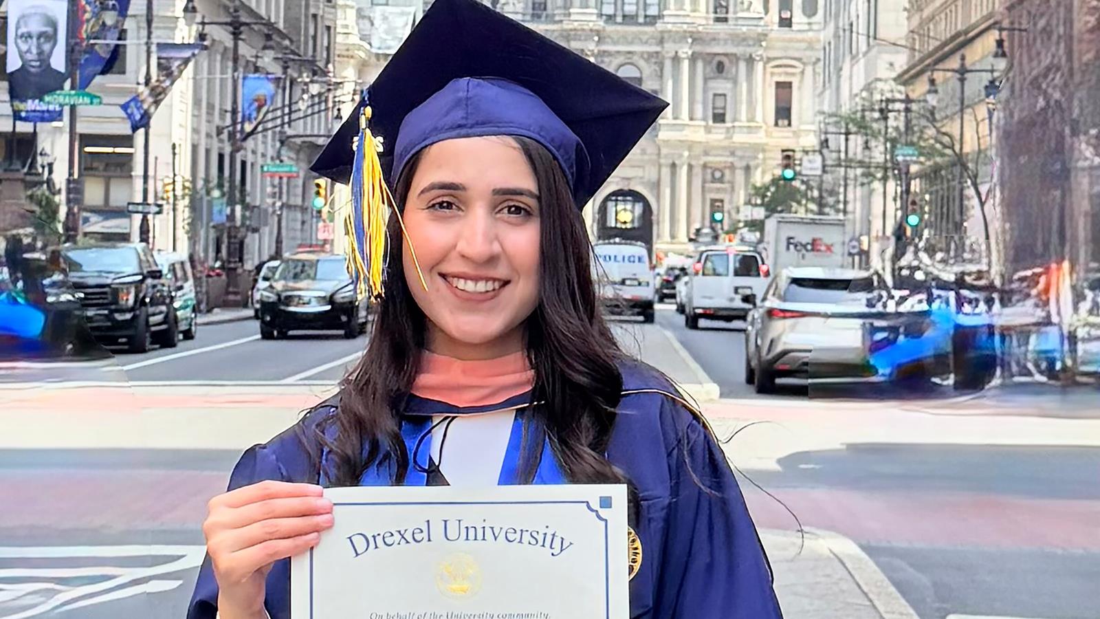 A Drexel University Graduate holding a diploma