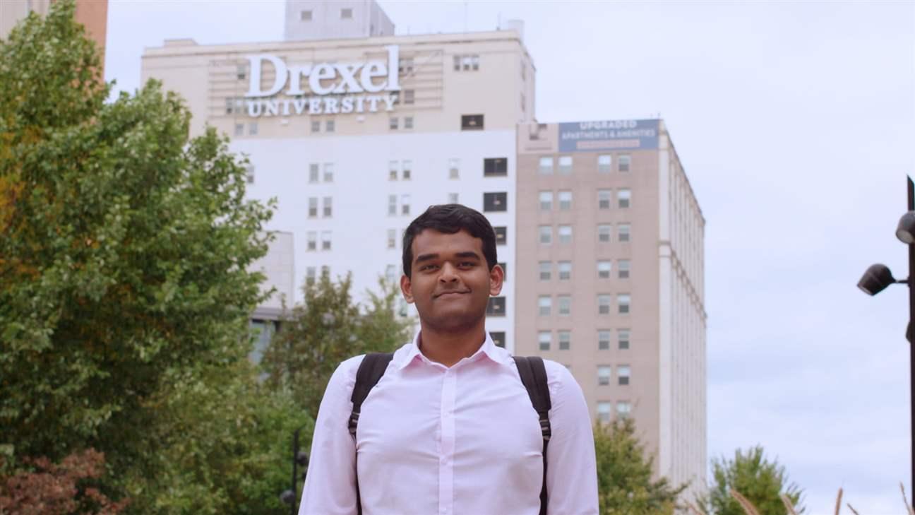 Student standing outside of Drexel campus building)
