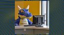 AI image created by DALL.E using the prompt "Drexel University Mario the Dragon doing homework on a computer"