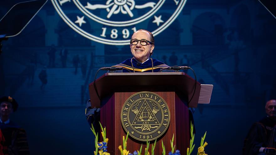President Antonio Merlo at a podium in his robes
