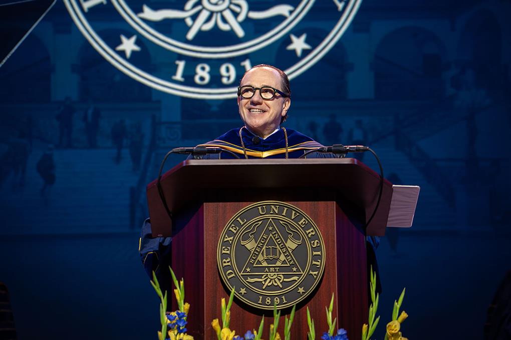 President Antonio Merlo at a podium in his robes