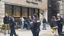 Police officers and community residents standing and getting coffee on a sidewalk