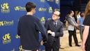 Merlo shakes hands with student