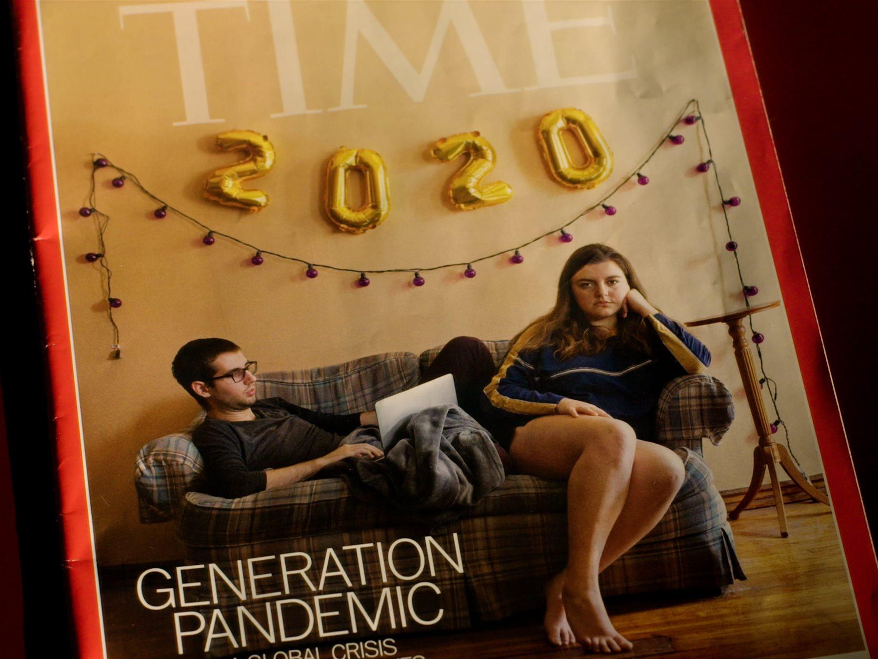 Two students sit on a couch under a 2020 banner on a &quot;TIME&quot; magazine cover