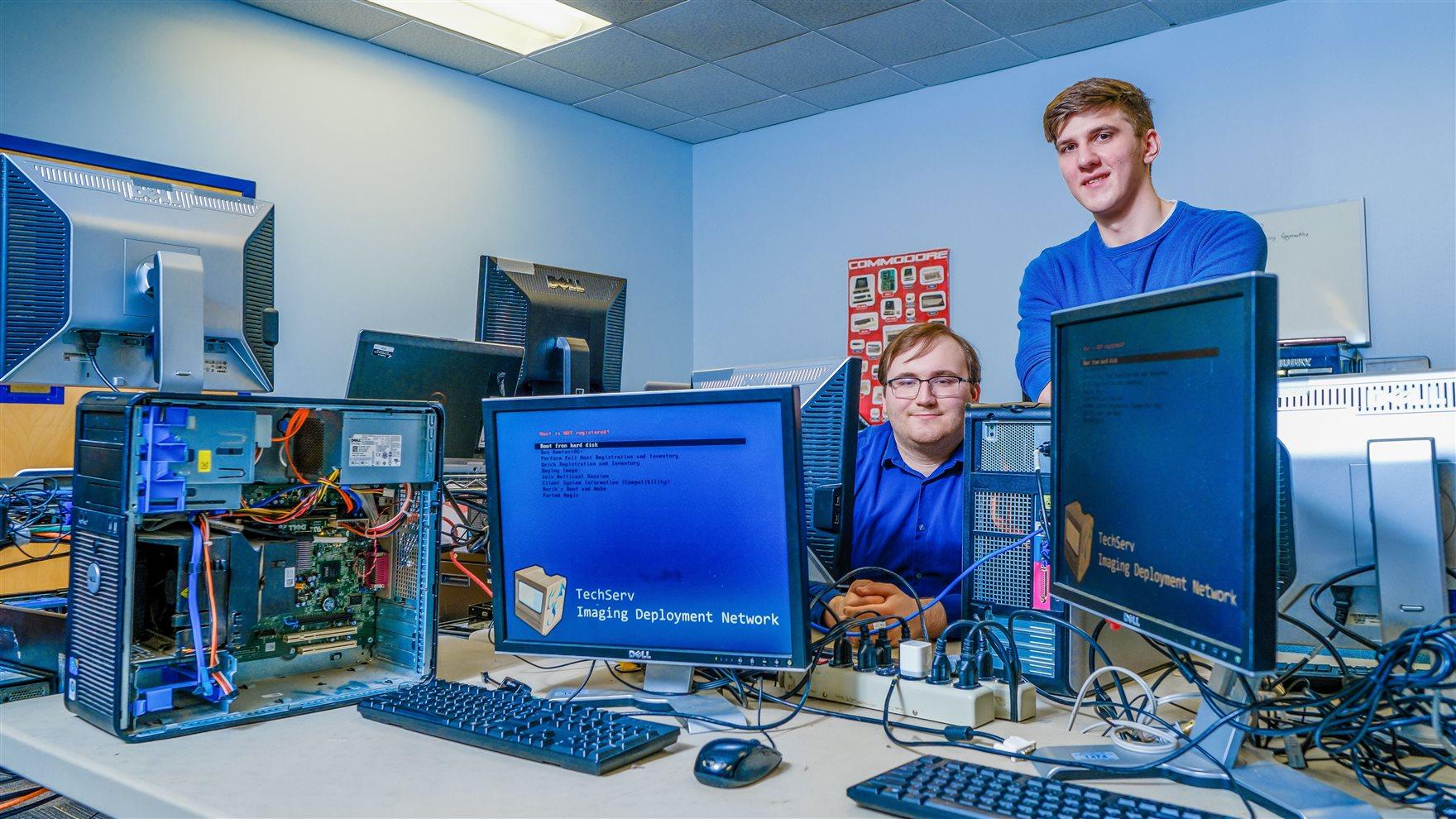 Tim Ryer, a third-year and software engineering major, left, and Daniel Dinu, BS/MS computer engineering ’23, right. Tim is the president of TechServe, and Daniel is the vice president. Photo credit: Jeff Fusco. 