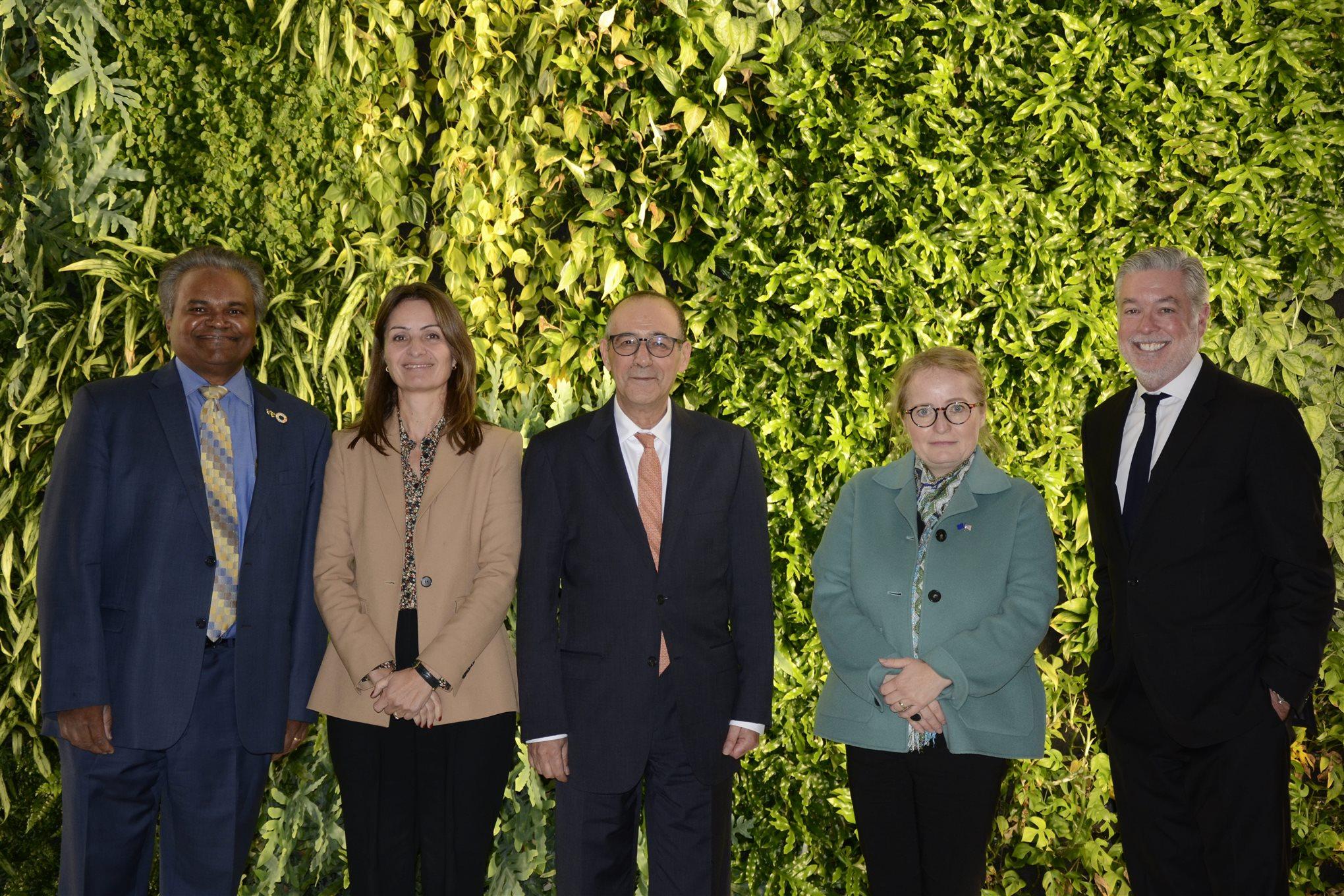 EU ambassadors with Mathy Stanislaus and John Fry, posed in front of Drexel&#39;s Biowall.