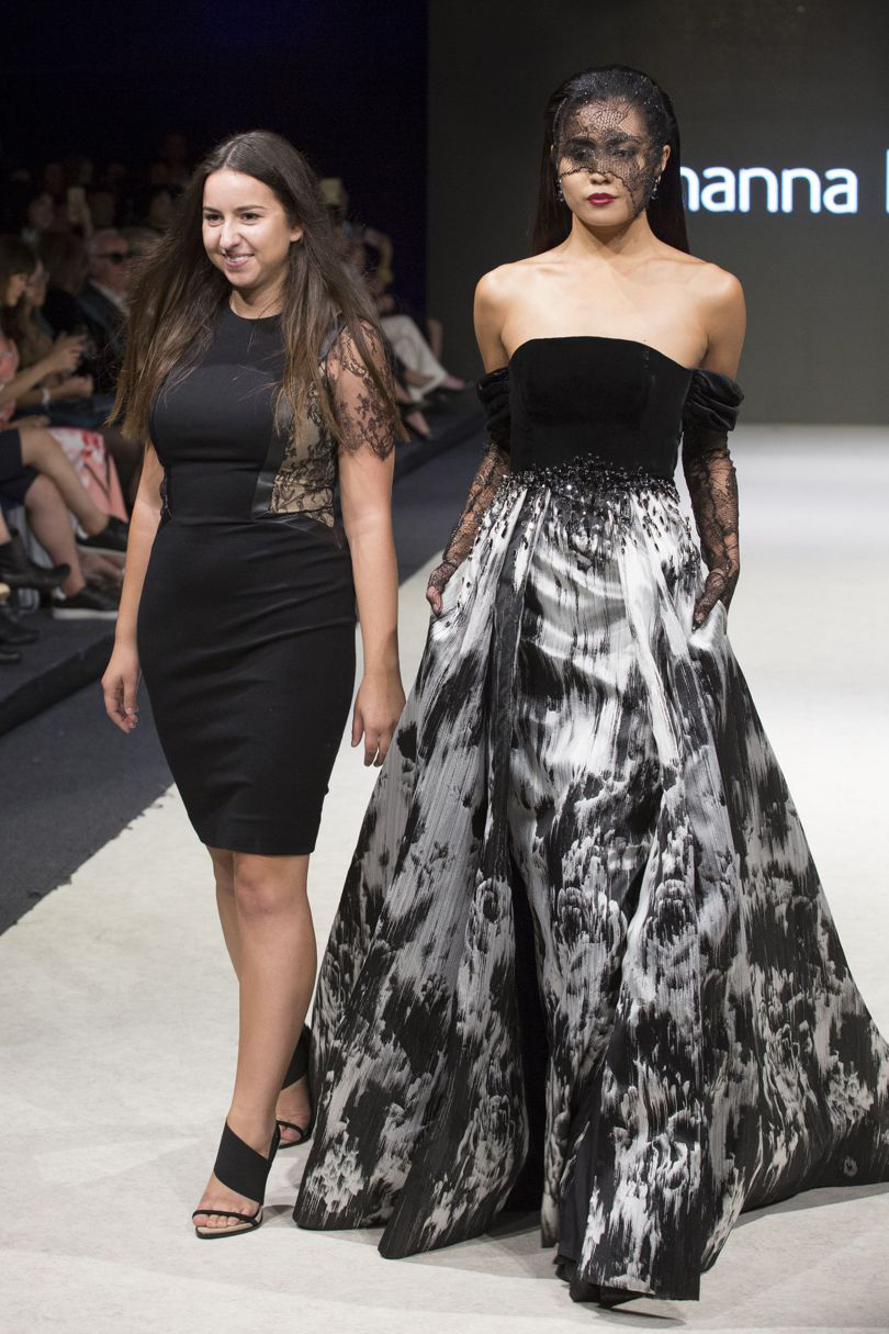 Dinardo on runway with model in black dress