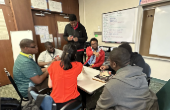 A group of students having a conversation around a table