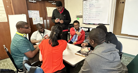 A group of students having a conversation around a table