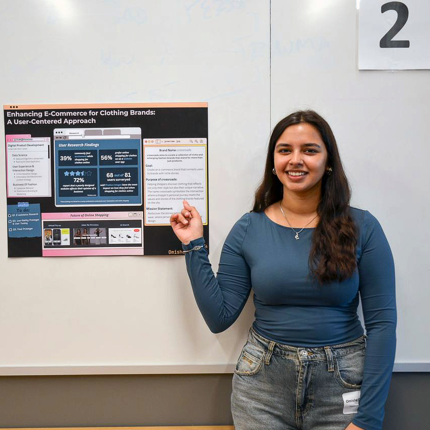 Omisha Chabria demonstrating her CSDN capstone project poster