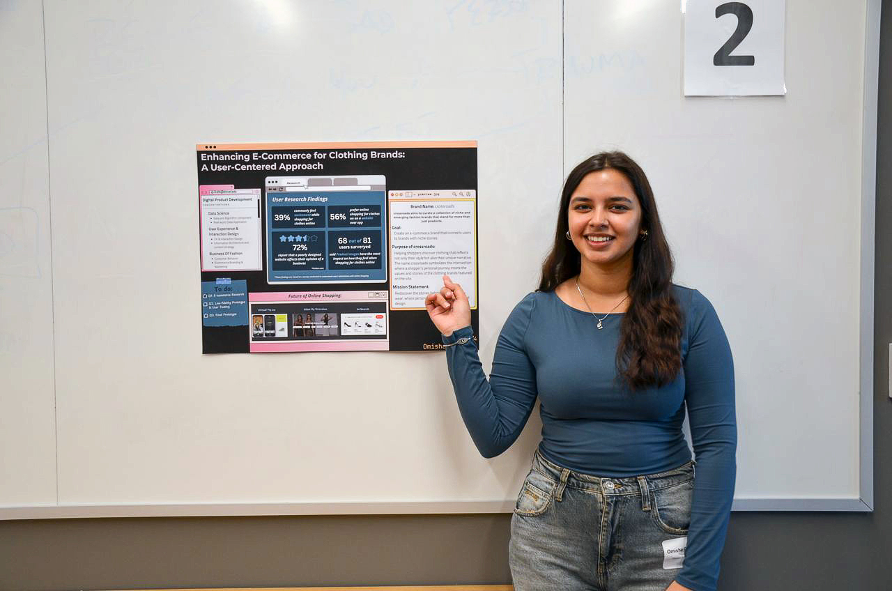 Omisha Chabria demonstrating her CSDN capstone project poster