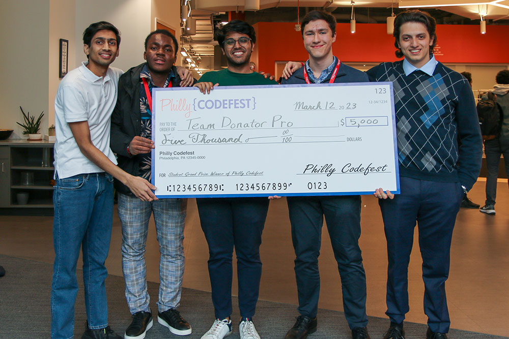 Team Donator Pro stands with giant check at Philly Codefest 2023