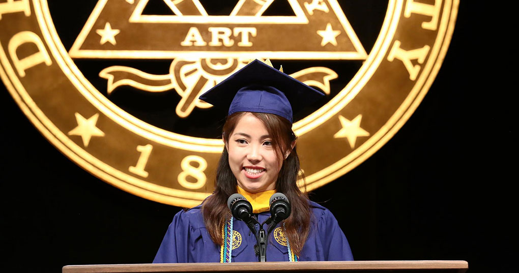 Tiffany Wong (BS Computer Science, '18) speaking at the 2018 Commencement in the Daskalakis Athletic Center. 
