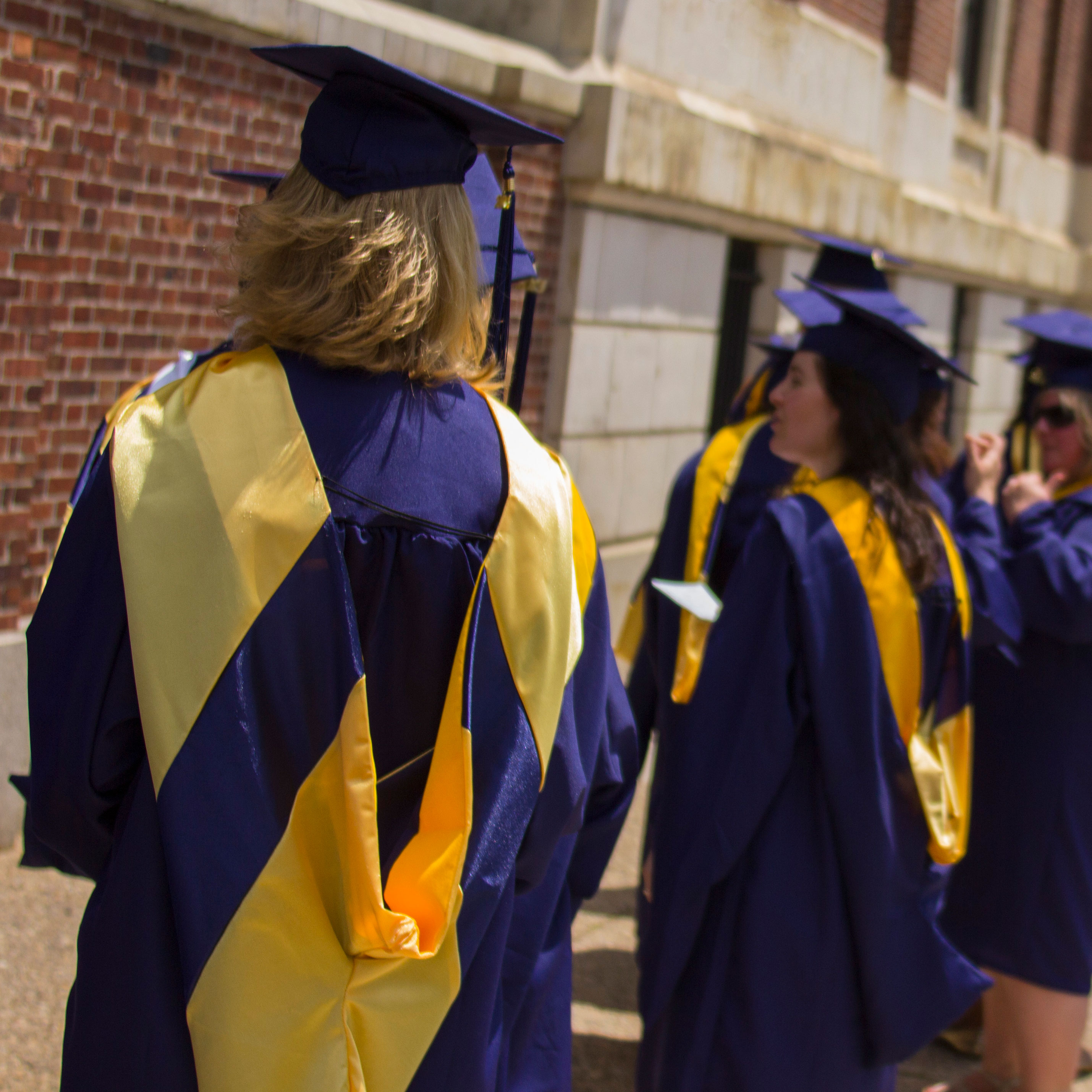 A person with blond hair wearing Drexel graduation regalia