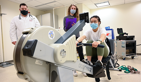 Michael Bruneau, PhD and Health Sciences students using rower machine