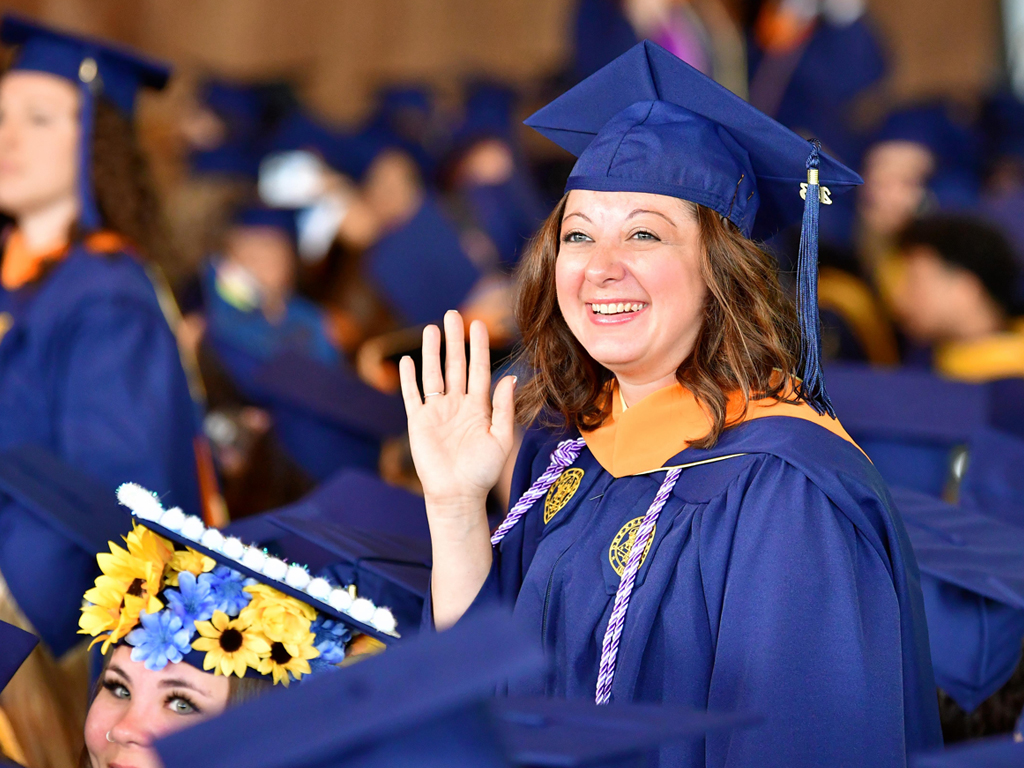 graduate waving in the crowd