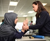 Sarah Wenger, PT, DPT works with patient with arm pain in the gym
