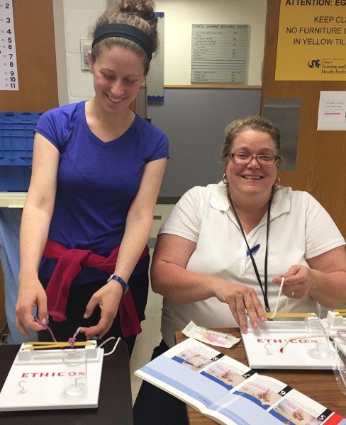 Physician Assistant Clinical Instructor Clare Pisoni, MPAS, PA-C and student prepping for class