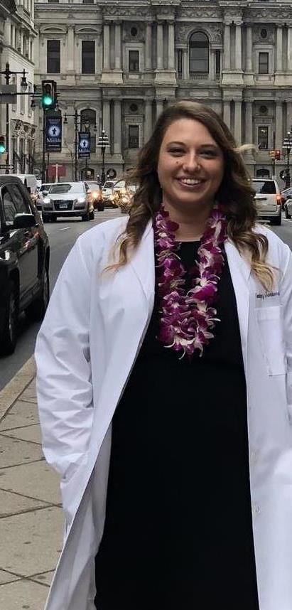 Jankowski standing outside in front of City Hall in a white coat