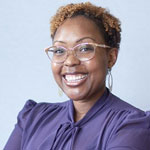 Smiling woman in front of a blue backdrop