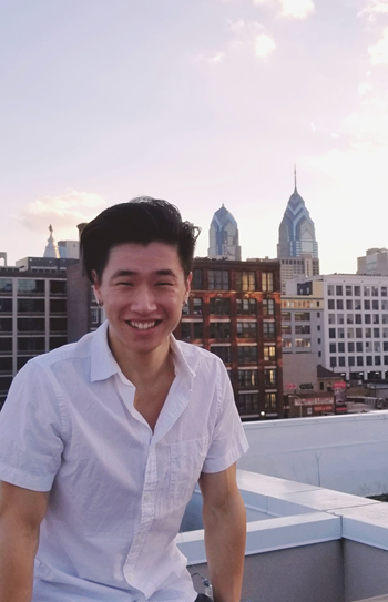 student smiling in front of a skyline