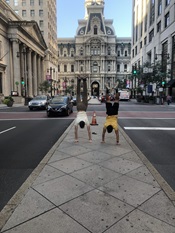 Chris, handstand with a friend, in front of City Hall in Philadelphia 