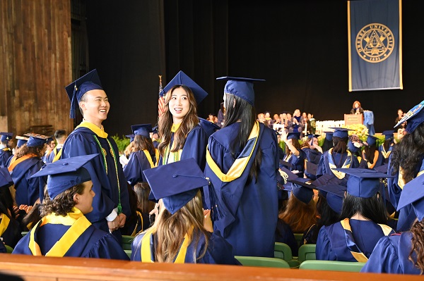 Graduates wearing Drexel University caps and gowns at the College of Nursing and Health Professions graduation ceremony