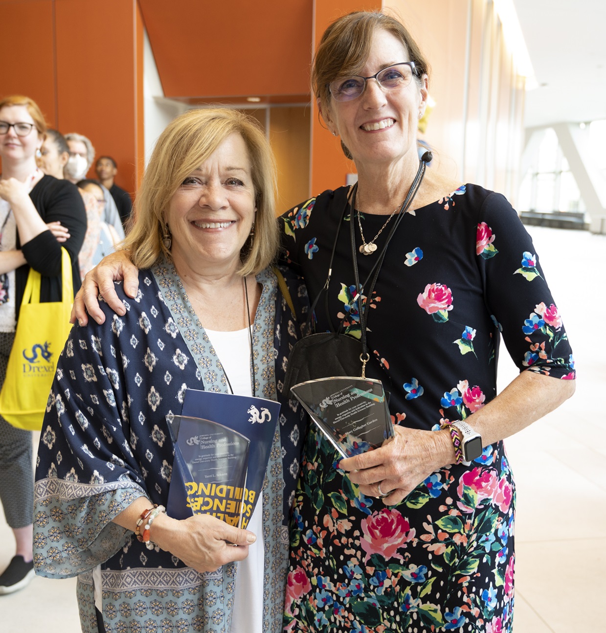 Terri Schmitt and Mary Gallagher Gordon, PhD holding their recognition awards during the College of Nursing and Health Professions open house in the new Drexel Health Science Building.