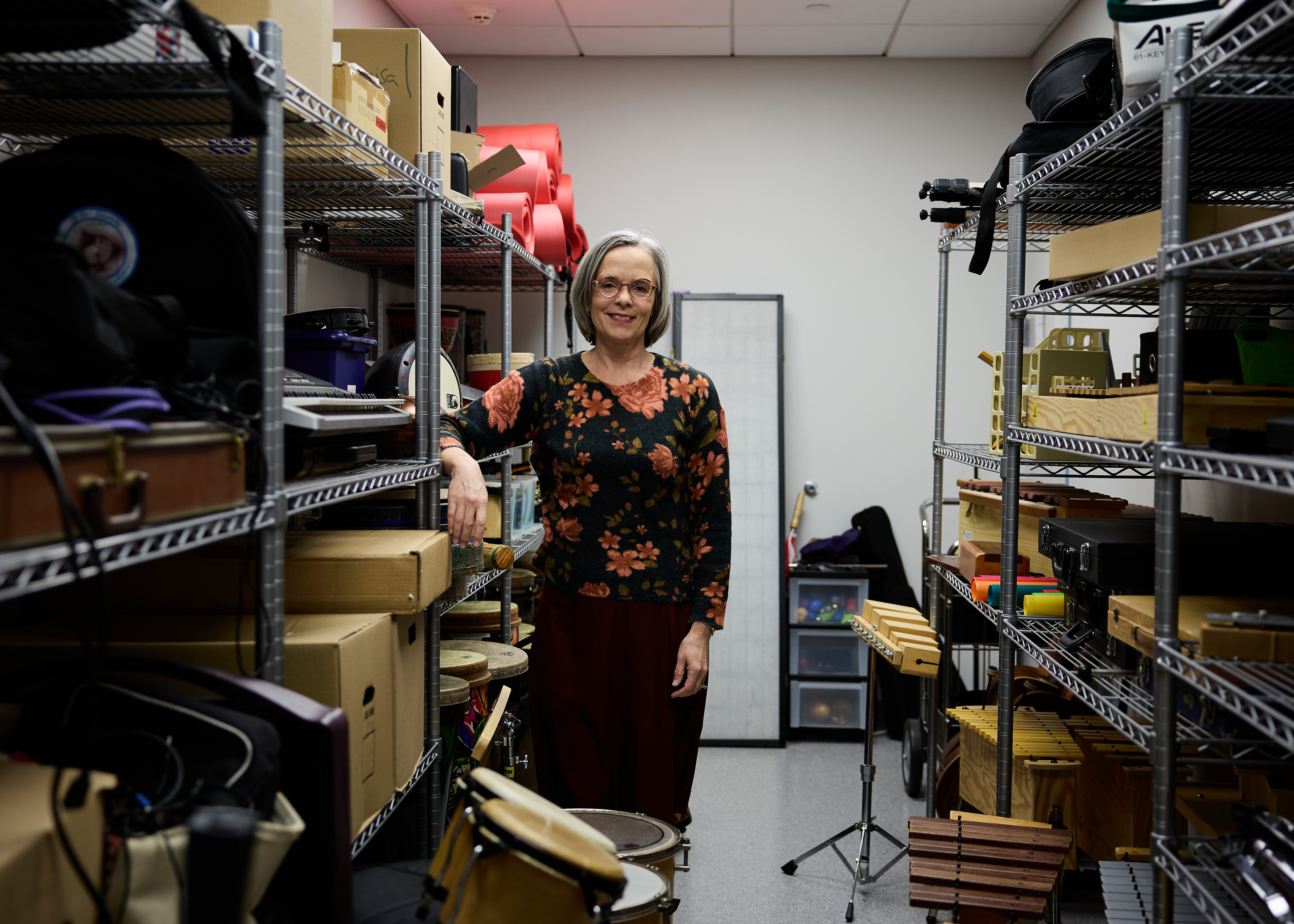 Yoke Bradt, PhD surrounded by instruments in classroom storage unit
