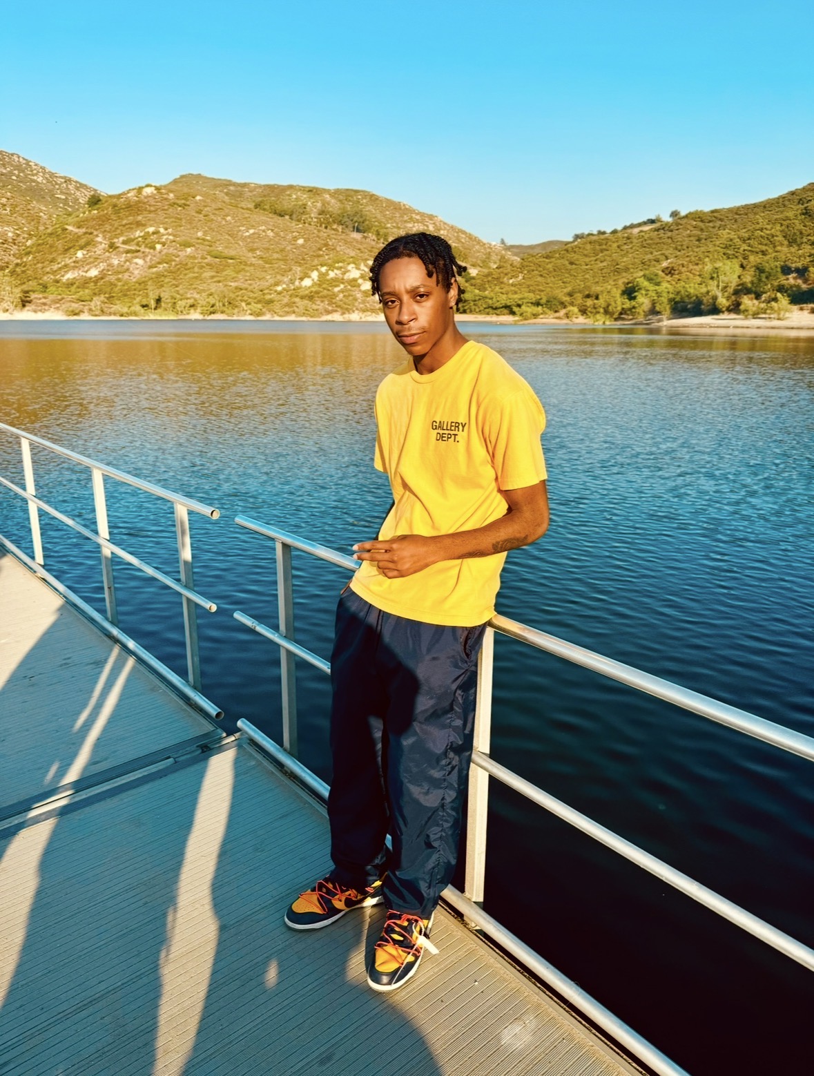 Photo of exercise science Jahlil Gary standing on a bridge with a scenic view