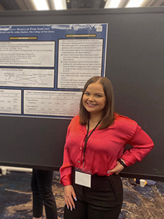 Chloe Hessler standing next to presentation.