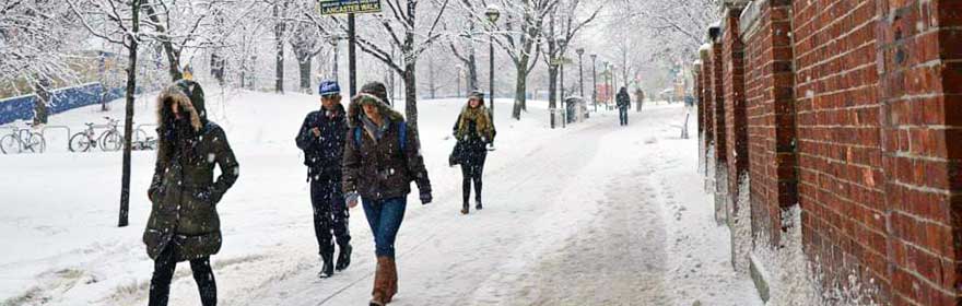 Drexel students travel on foot to their classes along snowy Lancaster Walk.