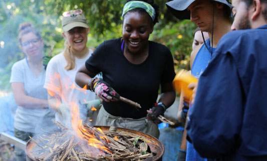 Alexis making biochar with other Drexel students.