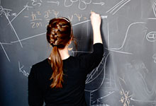student working at chalkboard
