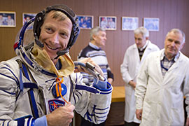 Drexel Alumni and Astronaut Christopher Ferguson goes through a suit fit check
