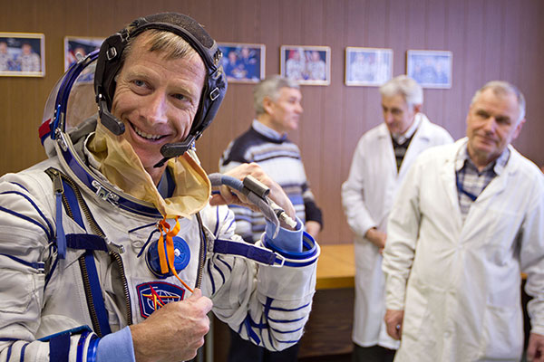 Drexel Alumni and Astronaut Christopher Ferguson goes through a suit fit check