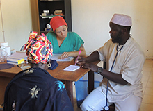 Drexel Chemistry Major Victoria Smith with a doctor and patient in a hospital in The Gambia