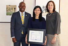 Drexel Provost Brian Blake and Senior VP for Faculty Affairs Erin Horvat giving an award to Professor Zoe Zhang