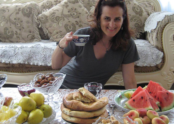 Rebecca Clothey, PhD, in Xinjiang with typical Uyghur snacks