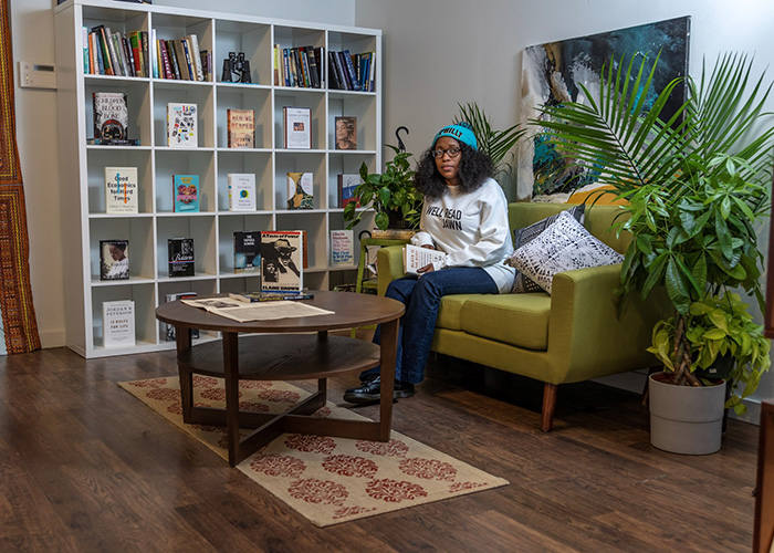 Jeanine Cook sitting on couch inside Harriett's Bookshop in Fishtown